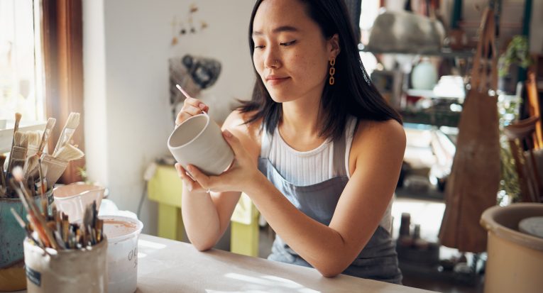 Pottery, art and sculpture with a japanese woman in a studio for design or a creative hobby as an a.